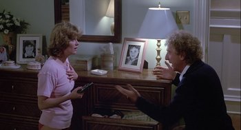 Movie still from “The Woman in Red” (1984), directed by Gene Wilder – A man and a woman talking in front of a lamp; Medium shot, Over the shoulder angle