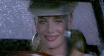 Movie still from “The Woman in Red” (1984), directed by Gene Wilder – A beautiful woman with blue eyes wearing a hat; Close Up shot, Over the shoulder angle