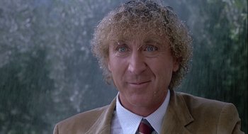 Movie still from “The Woman in Red” (1984), directed by Gene Wilder – A person wearing a suit and tie; Close Up shot, Low angle