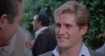 Movie still from “The Woman in Red” (1984), directed by Gene Wilder – A person with a beard; Close Up shot, Over the shoulder angle