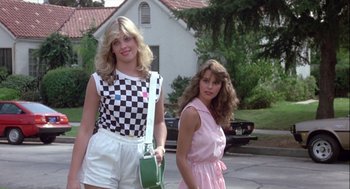 Movie still from “The Woman in Red” (1984), directed by Gene Wilder – Two young women standing next to each other on the street; Medium shot, Low angle