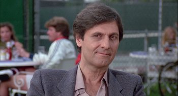 Movie still from “The Woman in Red” (1984), directed by Gene Wilder – A person wearing a suit and tie; Close Up shot, Low angle