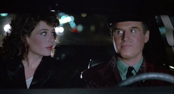 Movie still from “The Woman in Red” (1984), directed by Gene Wilder – A man and a woman sitting in the back of a car; Close Up shot, Over the shoulder angle