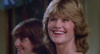 Movie still from “The Woman in Red” (1984), directed by Gene Wilder – A person smiling; Close Up shot, Low angle