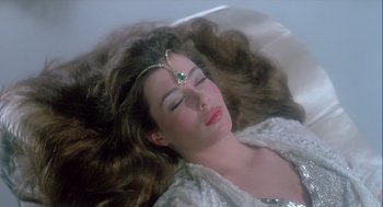 Movie still from “The Woman in Red” (1984), directed by Gene Wilder – A beautiful woman laying in a bath tub; Close Up shot, High angle