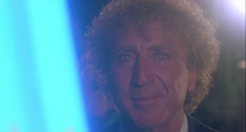 Movie still from “The Woman in Red” (1984), directed by Gene Wilder – A person wearing a suit and tie; Close Up shot, Over the shoulder angle