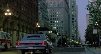 Movie still from “The Woman in Red” (1984), directed by Gene Wilder – A car parked on the side of the road at night; Extreme Wide shot, Low angle