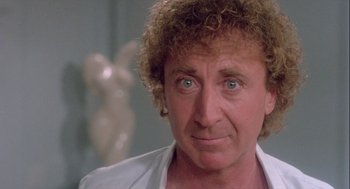 Movie still from “The Woman in Red” (1984), directed by Gene Wilder – A person wearing a white shirt; Close Up shot, Over the shoulder angle