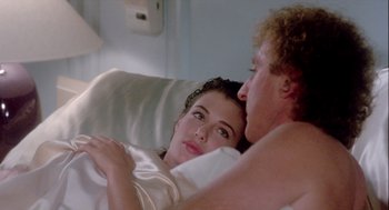 Movie still from “The Woman in Red” (1984), directed by Gene Wilder – A man and a woman laying in a bed; Close Up shot, Over the shoulder angle