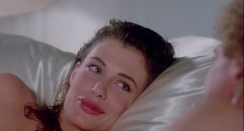 Movie still from “The Woman in Red” (1984), directed by Gene Wilder – A person laying in a bed; Close Up shot, Over the shoulder angle