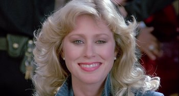 Movie still from “The Woman in Red” (1984), directed by Gene Wilder – A woman with blonde hair; Close Up shot, Low angle