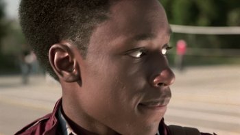 Movie still from “The Wood” (1999), directed by Rick Famuyiwa – A young man's face with light shining on it's eyes; Close Up shot, Low angle