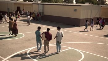 Movie still from “The Wood” (1999), directed by Rick Famuyiwa – A group of young men standing on a basketball court; Extreme Wide shot, High angle