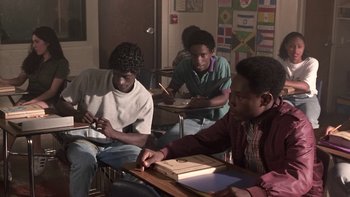 Movie still from “The Wood” (1999), directed by Rick Famuyiwa – A group of young men sitting at a table; Medium shot, High angle