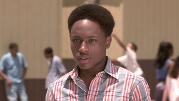 Movie still from “The Wood” (1999), directed by Rick Famuyiwa – A young man in a red and blue striped shirt; Close Up shot, Low angle