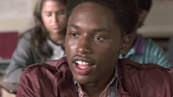 Movie still from “The Wood” (1999), directed by Rick Famuyiwa – A person with a person in the background; Close Up shot, Low angle
