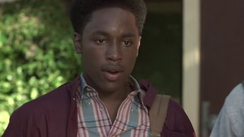 Movie still from “The Wood” (1999), directed by Rick Famuyiwa – A young man wearing a red and white striped shirt; Close Up shot, Low angle