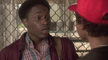 Movie still from “The Wood” (1999), directed by Rick Famuyiwa – A young man talking to another young man in front of a chain link fence; Close Up shot, Over the shoulder angle