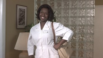 Movie still from “The Wood” (1999), directed by Rick Famuyiwa – A woman in a white uniform holding a purse; Medium shot, Low angle