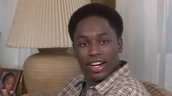 Movie still from “The Wood” (1999), directed by Rick Famuyiwa – A young black man wearing a plaid shirt and a tie; Close Up shot, High angle