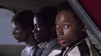 Movie still from “The Wood” (1999), directed by Rick Famuyiwa – A group of young men sitting next to each other; Close Up shot, Over the shoulder angle