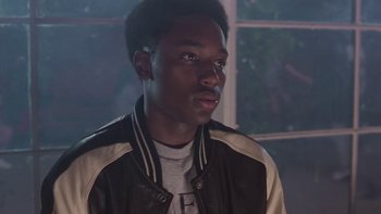 Movie still from “The Wood” (1999), directed by Rick Famuyiwa – A young man in a leather jacket looking to his left; Close Up shot, Over the shoulder angle