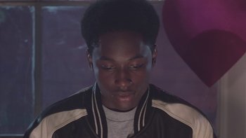 Movie still from “The Wood” (1999), directed by Rick Famuyiwa – A young man with his eyes closed and his head tilted to the side; Close Up shot, Over the shoulder angle