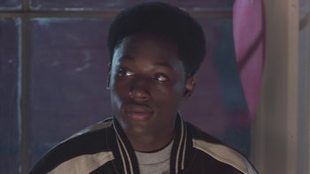 Movie still from “The Wood” (1999), directed by Rick Famuyiwa – A young man in a brown and white jacket looking to his left; Close Up shot, Over the shoulder angle