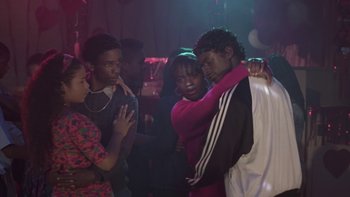 Movie still from “The Wood” (1999), directed by Rick Famuyiwa – A group of young people standing around each other in a room; Medium shot, Over the shoulder angle