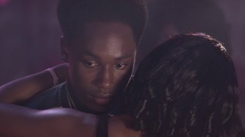 Movie still from “The Wood” (1999), directed by Rick Famuyiwa – A man and a woman embracing each other in a dark room; Close Up shot, Over the shoulder angle