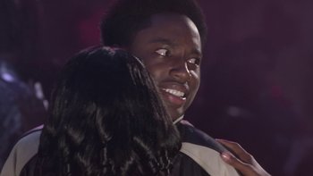 Movie still from “The Wood” (1999), directed by Rick Famuyiwa – A man and a woman embracing each other in front of a dark background; Close Up shot, Over the shoulder angle