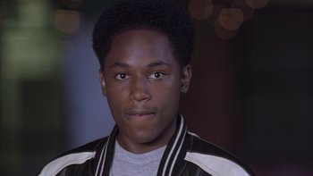 Movie still from “The Wood” (1999), directed by Rick Famuyiwa – A man with a black and white jacket on; Close Up shot, High angle