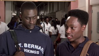 Movie still from “The Wood” (1999), directed by Rick Famuyiwa – Two young men standing next to each other in front of a group of people; Close Up shot, High angle