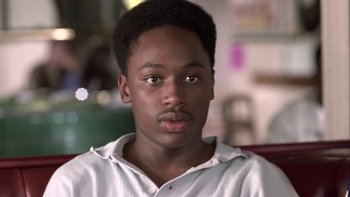 Movie still from “The Wood” (1999), directed by Rick Famuyiwa – A person wearing a white t - shirt; Close Up shot, High angle