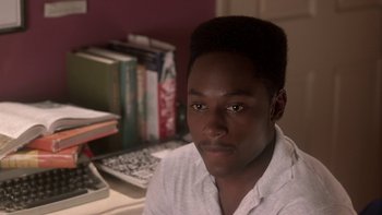 Movie still from “The Wood” (1999), directed by Rick Famuyiwa – A young man sitting in front of a computer desk; Close Up shot, High angle