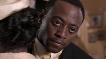 Movie still from “The Wood” (1999), directed by Rick Famuyiwa – A person wearing a suit and tie; Close Up shot, High angle