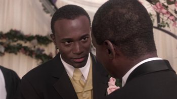 Movie still from “The Wood” (1999), directed by Rick Famuyiwa – A man in a suit and tie looking at another man in a suit and tie; Close Up shot, Over the shoulder angle