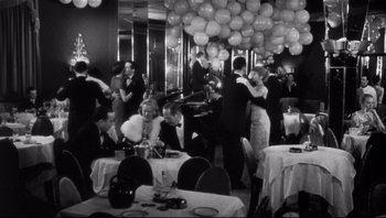 Movie still from “The Wrong Man” (1956), directed by Alfred Hitchcock – A black and white photo of people dancing at a party; Wide shot, High angle