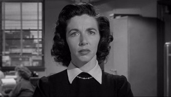 Movie still from “The Wrong Man” (1956), directed by Alfred Hitchcock – An old photo of a woman in a black and white photo; Close Up shot, Low angle