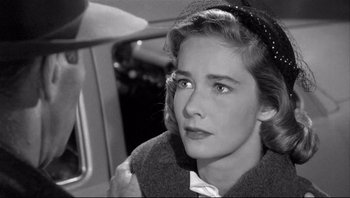 Movie still from “The Wrong Man” (1956), directed by Alfred Hitchcock – A black - and - white photo of a woman looking at the camera; Close Up shot, Over the shoulder angle