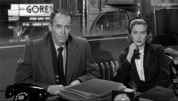 Movie still from “The Wrong Man” (1956), directed by Alfred Hitchcock – A man and a woman sitting at a table in a restaurant; Medium shot, Over the shoulder angle