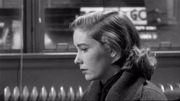 Movie still from “The Wrong Man” (1956), directed by Alfred Hitchcock – A black - and - white photo of a woman looking to her left; Close Up shot, Over the shoulder angle