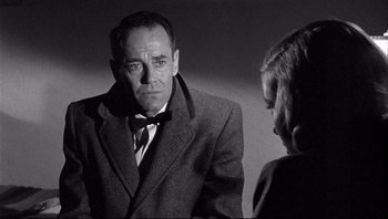 Movie still from “The Wrong Man” (1956), directed by Alfred Hitchcock – A black and white photo of a man and a woman; Close Up shot, Over the shoulder angle