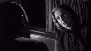 Movie still from “The Wrong Man” (1956), directed by Alfred Hitchcock – A man and a woman are looking in the same direction; Close Up shot, Over the shoulder angle