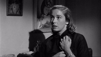 Movie still from “The Wrong Man” (1956), directed by Alfred Hitchcock – A black - and - white photo of a woman holding a cat; Close Up shot, Over the shoulder angle