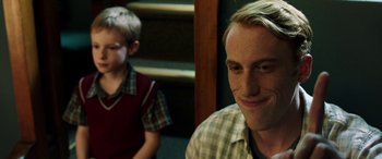 Movie still from “The Young and Prodigious T.S. Spivet” (2013), directed by Jean-Pierre Jeunet – A man and a boy are smiling for the camera; Close Up shot, Over the shoulder angle