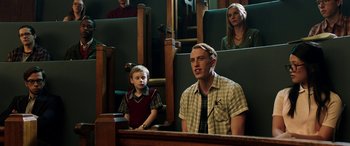 Movie still from “The Young and Prodigious T.S. Spivet” (2013), directed by Jean-Pierre Jeunet – A man and a boy are sitting in a court room; Medium shot, High angle