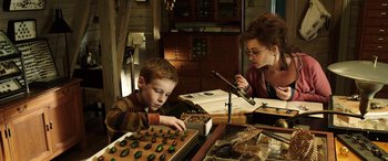 Movie still from “The Young and Prodigious T.S. Spivet” (2013), directed by Jean-Pierre Jeunet – A woman and a boy working on a project; Medium shot, High angle