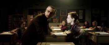 Movie still from “The Young and Prodigious T.S. Spivet” (2013), directed by Jean-Pierre Jeunet – A group of people sitting at a table with papers; Medium shot, Over the shoulder angle