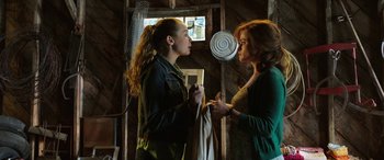Movie still from “The Young and Prodigious T.S. Spivet” (2013), directed by Jean-Pierre Jeunet – A woman and a young girl are standing in front of a fan; Medium shot, Over the shoulder angle